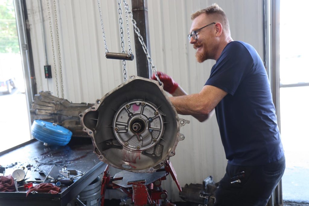 A technician moves a remanufactured unit at a transmission shop in Springfield MO.